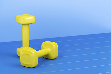 Image showing Two yellow dumbbells