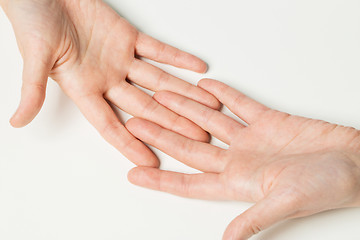 Image showing close up of two hands connecting fingers together