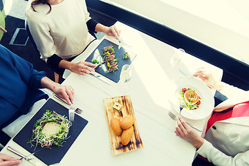 Image showing close up of women eating appetizer at restaurant