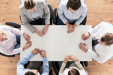 Image showing close up of business team sitting at table