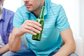 Image showing close up of man friends drinking beer at home