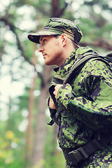 Image showing young soldier with backpack in forest