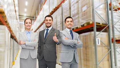 Image showing happy business team at warehouse showing thumbs up