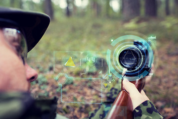 Image showing close up of soldier or sniper with gun in forest