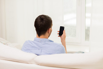 Image showing close up of man with smartphone at home