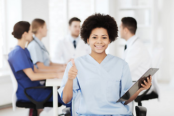 Image showing happy doctor over group of medics at hospital