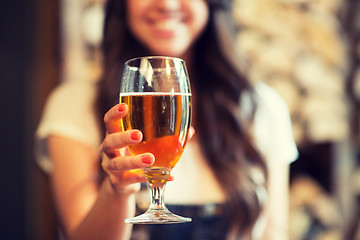 Image showing happy woman holding glass of draft lager beer