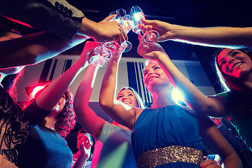 Image showing smiling friends with glasses of champagne in club