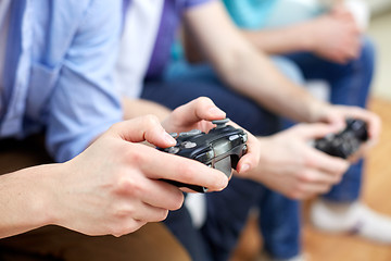 Image showing close up of friends playing video games at home