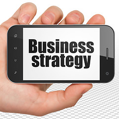 Image showing Finance concept: Hand Holding Smartphone with Business Strategy on display