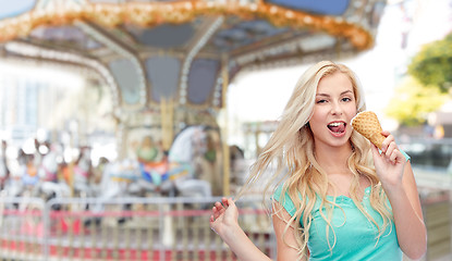 Image showing happy young woman in sunglasses eating ice cream