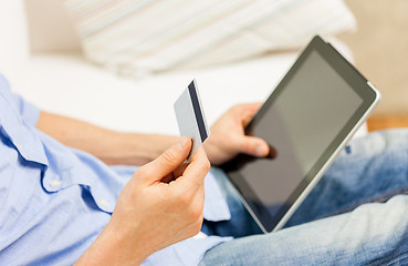 Image showing close up of man with tablet pc and credit card