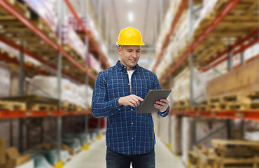 Image showing happy businessman with tablet pc at warehouse