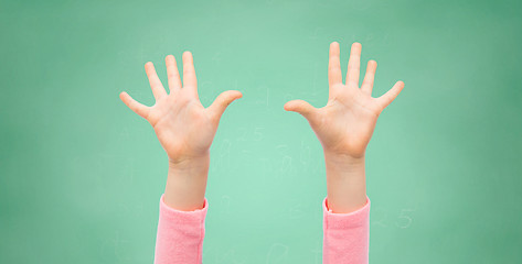 Image showing close up of little child hands raised upwards