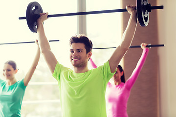 Image showing group of people exercising with barbell in gym