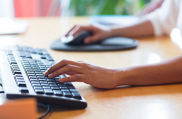 Image showing close up of female hands with keyboard and mouse