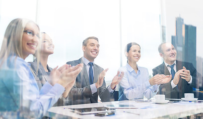 Image showing business team with laptop clapping hands