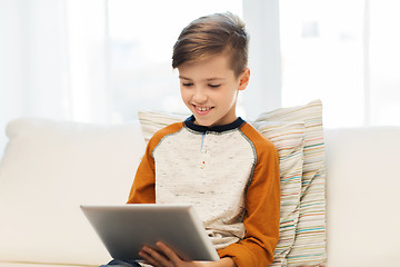 Image showing smiling boy with tablet computer at home