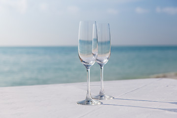 Image showing  close up of two champagne glasses on beach 