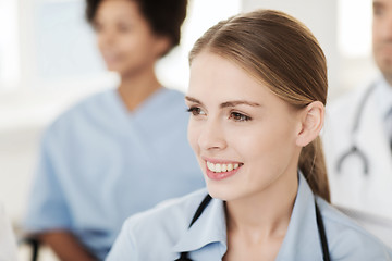 Image showing happy doctor over group of medics at hospital