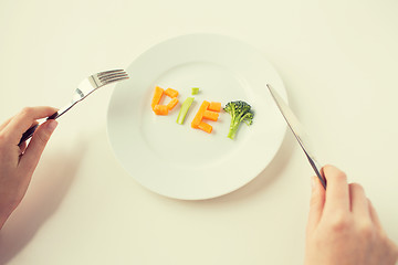 Image showing close up of woman hands eating vegetables