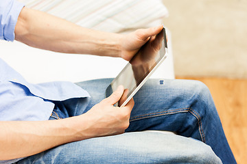 Image showing close up of man working with tablet pc at home