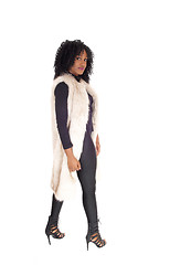 Image showing African American woman walking in fur coat.
