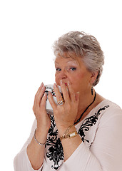 Image showing Senior woman drinking her sup.