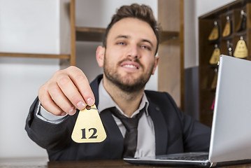 Image showing Receptionist Giving the Key