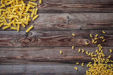 Image showing Mixed dried pasta selection on wooden background.