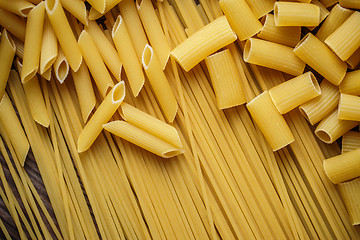 Image showing close up portrait of raw homemade italian pasta, macaroni, spaghetti, and fettuccine