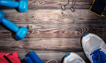 Image showing Sport stuff on wooden table, top view