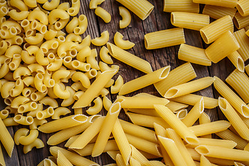 Image showing close up portrait of raw homemade italian pasta, macaroni, spaghetti, and fettuccine