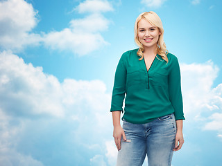 Image showing smiling young woman in shirt and jeans