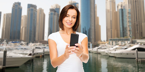 Image showing woman taking selfie by smartphone over dubai city