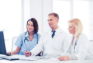 Image showing doctors looking at computer on meeting