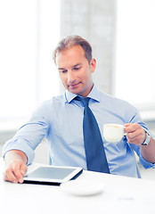 Image showing businessman with tablet pc and coffee in office