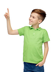 Image showing happy boy in green polo t-shirt pointing finger up