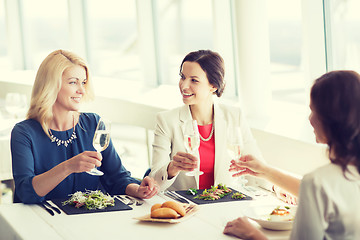 Image showing happy women drinking champagne at restaurant