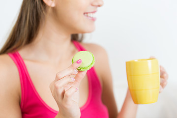 Image showing close up of happy woman or teen girl with cookie 