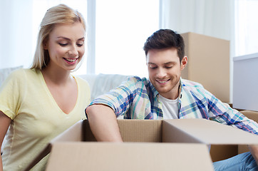 Image showing smiling couple with big boxes moving to new home