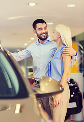 Image showing happy couple buying car in auto show or salon