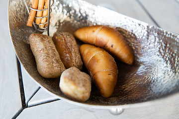 Image showing close up of buns in bowl at cafe or bakery