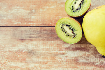 Image showing close up of ripe kiwi and pear on table