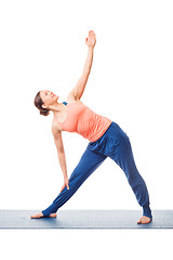 Image showing Sporty fit woman practices yoga asana utthita trikonasana