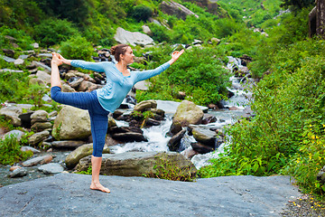 Image showing Woman doing yoga asana outdoors at waterfall