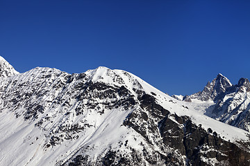 Image showing Snowy mountains and blue clear sky at nice sun day