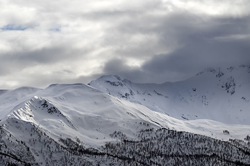 Image showing Evening sunlight mountains and gray cloudy sky