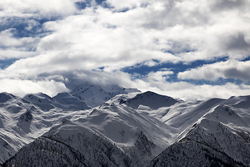 Image showing View on snowy mountains and cloudy sky at evening