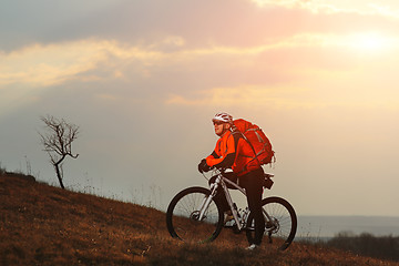 Image showing Man cyclist with backpack riding the bicycle